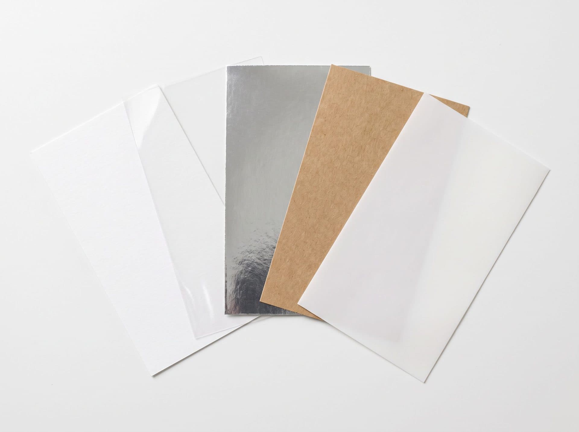 Label material swatches: white paper, clear film, metallic, kraft and polypropylene